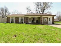 Charming single story brick home with well-maintained lawn and inviting front porch at 5909 Furnas Rd, Indianapolis, IN 46221