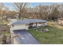 Well-maintained ranch home boasts attached garage, beautiful yard and brick accents at 6914 Honnen W Dr, Indianapolis, IN 46256