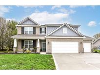 Charming two-story home with brick facade, attached garage, and well-manicured lawn at 698 Ridge Gate Dr, Brownsburg, IN 46112