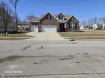 Charming two-story brick home featuring a two-car garage and well-maintained landscaping at 720 Erin Dr, Avon, IN 46123