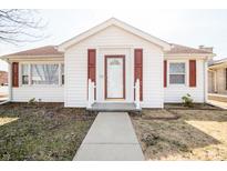 Charming one-story home with white siding, red shutters, and welcoming front entry at 1607 25Th St, Columbus, IN 47201