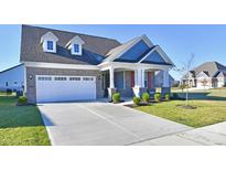 Charming two-story home with brick accents, a two-car garage, and well-manicured front yard at 2186 Chick Evans Way, Westfield, IN 46074
