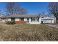 Charming ranch-style home featuring green shutters, brick accents, and a well-maintained lawn and landscaping at 310 Sundown Mnr, Mooresville, IN 46158