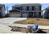 Two-story blue home featuring a two car garage, covered front porch, and available signage at 3548 Planck Cir, Danville, IN 46122