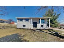 Charming two-story home features a well-maintained front yard and classic architectural details at 4432 Standish Dr, Indianapolis, IN 46221
