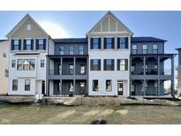 Beautiful townhome exterior featuring modern architectural details, neutral colors, and covered patios at 477 Mariposa Trl, Carmel, IN 46032
