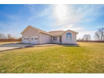 Inviting single-story home with attached two-car garage and well-manicured lawn at 4851 W 250 S, Anderson, IN 46011