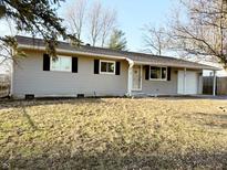 Charming single-story home with light gray siding and black shutters on a bright, sunny day at 5109 Bertha St, Indianapolis, IN 46241