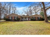 Charming brick home with a manicured front yard and classic shutters at 5785 Susan E Dr, Indianapolis, IN 46250