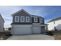 Two-story home featuring gray siding, white brick accents, and an attached two-car garage at 5840 Sunstone Rd, Indianapolis, IN 46239