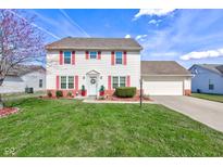 Charming two-story home with well-manicured lawn, red shutters and an attached garage at 6843 Long Run Dr, Indianapolis, IN 46268