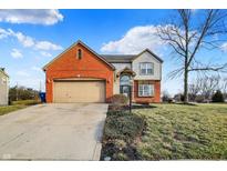 Charming two-story home with a two-car garage, brick accents and a well-maintained front yard at 7058 Starkey Ridge Ln, Indianapolis, IN 46268