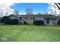 Charming single-story home with mature landscaping and a well-maintained lawn at 710 Hanna St, Plainfield, IN 46168