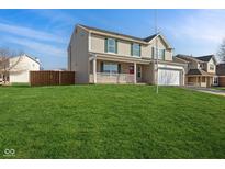Charming two-story home featuring a well-manicured lawn, two-car garage, and inviting front porch at 775 Hummingbird Ln, Whiteland, IN 46184