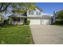 Charming two-story home featuring a welcoming porch and a three car attached garage at 11458 Falling Water Way, Fishers, IN 46037