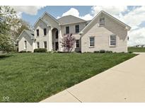 Charming two-story home with brick exterior, manicured lawn and lush landscaping at 1358 Rutherglen Ct, Danville, IN 46122