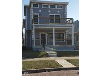 Charming two-story home with a large front porch and a second story deck for outdoor enjoyment at 1723 Fletcher Ave, Indianapolis, IN 46203