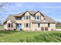 Stunning brick two-story home with a manicured lawn and a welcoming blue front door at 2274 W Huntsville Rd, Pendleton, IN 46064