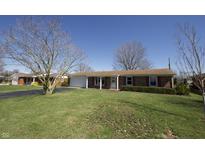 Charming single-story home with a well-manicured front lawn and brick exterior at 2525 Flintwood Dr, Columbus, IN 47203