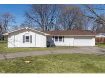 Charming single-story home with a white brick facade, attached garage and well-maintained front yard at 3540 W 55Th St, Indianapolis, IN 46228