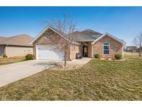 Charming single-story home featuring a brick exterior, attached garage, and well-maintained lawn at 4347 Westminster Pl, Columbus, IN 47201