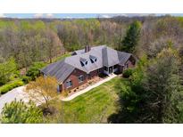 Expansive brick home with manicured lawn and lush surrounding trees at 4491 N 75 W, Franklin, IN 46184