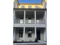 Beautiful multi-level townhome showcases stacked balconies with gray siding and complementary black accents at 457 Mariposa Trl, Carmel, IN 46032