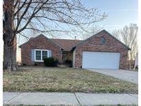 Cozy one-story brick home with a two car garage and charming blue shutters at 485 Paddlebrook Dr, Danville, IN 46122