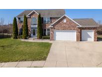 Charming two-story brick home with a well-maintained lawn and three car garage at 5852 Sunnyvalle Dr, Bargersville, IN 46106