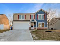 Charming two-story home featuring blue and tan siding, red shutters, and an attached two-car garage at 6417 Pinebark Pl, Indianapolis, IN 46217