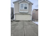 Attached two-car garage with neutral door, exterior lights, and concrete driveway at 6618 Stanhope Way, Indianapolis, IN 46254