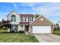 Charming two-story home with a well-manicured lawn and attached two-car garage at 712 Burr Oak Dr, Greenwood, IN 46143