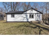 Charming home featuring white siding, black trim, and a well-maintained lawn at 7252 E 47Th St, Indianapolis, IN 46226