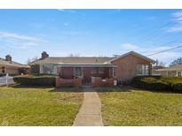 Charming brick home with a covered front porch and well-maintained landscaping at 847 Churchman Ave, Beech Grove, IN 46107