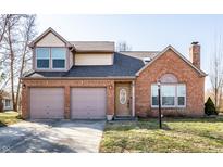 Charming two-story brick home with a two-car garage and well-maintained front yard at 8873 Falkirk Ct, Indianapolis, IN 46256