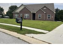 Beautiful brick single-story home featuring a well-manicured lawn and a charming mailbox at 10890 Poppy Hill Dr, Indianapolis, IN 46234