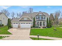 Stunning two-story home with a three-car garage and manicured lawn at 11367 Zanardi Ct, Zionsville, IN 46077