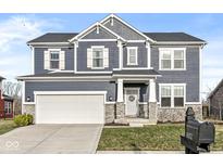 Charming two-story home featuring a two-car garage and stone accents at 16012 Trestle Dr, Westfield, IN 46074