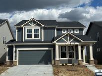Two-story home with a two-car garage, neutral trim, and newly planted landscaping at 2777 Penn Ave, Plainfield, IN 46168