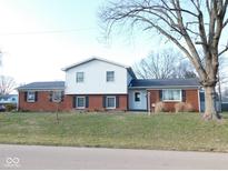 Charming brick and siding two-story home featuring well-maintained front yard and mature trees at 3300 Heritage Rd, Columbus, IN 47203