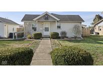 Charming single-story home with a landscaped front yard and welcoming walkway leading to the front door at 369 E Green St, Martinsville, IN 46151