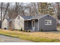 Charming single-story home featuring a covered porch, gray siding, and a well-maintained front yard at 426 Della Rd, Columbus, IN 47203