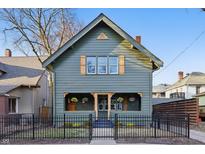 Charming two-story home featuring a fenced yard, inviting front porch and craftsman details at 46 E 36Th St, Indianapolis, IN 46205