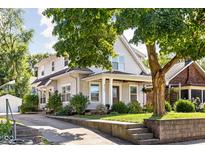 Charming two-story home with well-maintained landscaping, concrete driveway, and inviting front porch at 4707 N Park Ave, Indianapolis, IN 46205