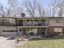 Two-story home featuring a two-car garage, brick accents, and balconies on the upper level at 490 Valley Dr, Martinsville, IN 46151
