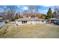 Charming single-story home with a stone facade, well-manicured lawn, and a welcoming front entrance at 5002 Kessler N Blvd, Indianapolis, IN 46228