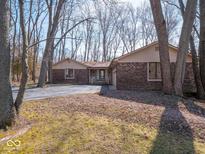 Charming brick home with a long driveway and a wooded lot creating a serene atmosphere at 5309 Michael Ct, Brownsburg, IN 46112