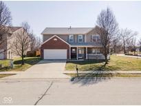 Charming two-story home features a brick front, attached garage, and welcoming front porch at 5897 W River Chase Ln, McCordsville, IN 46055