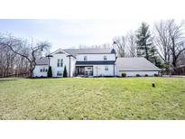A beautiful two-story home with a landscaped yard and charming front porch on a sunny day at 6149 W Country Ln, Anderson, IN 46011