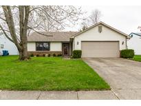 Charming single-Gathering home features a well-manicured lawn and attached two-car garage at 6704 Granger Ln, Indianapolis, IN 46268
